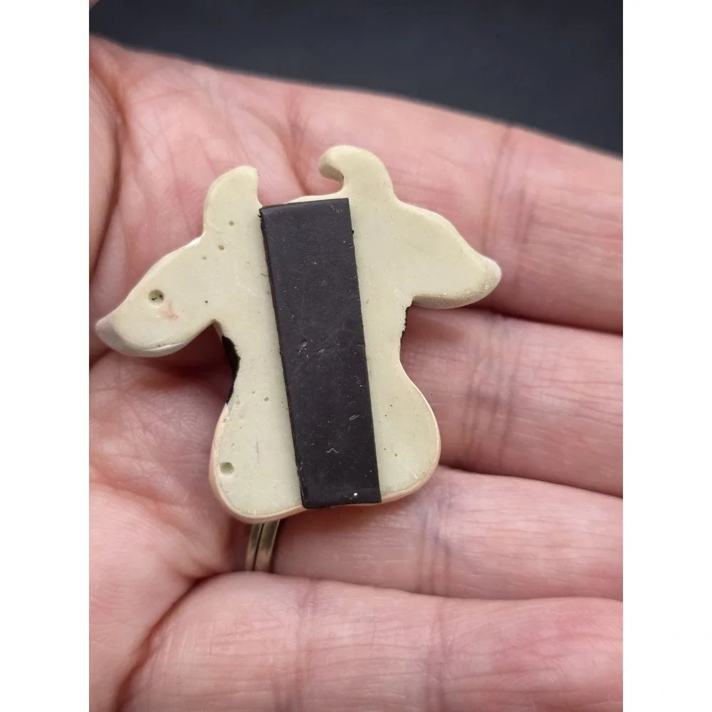 This collection features various vintage-style cow refrigerator magnets